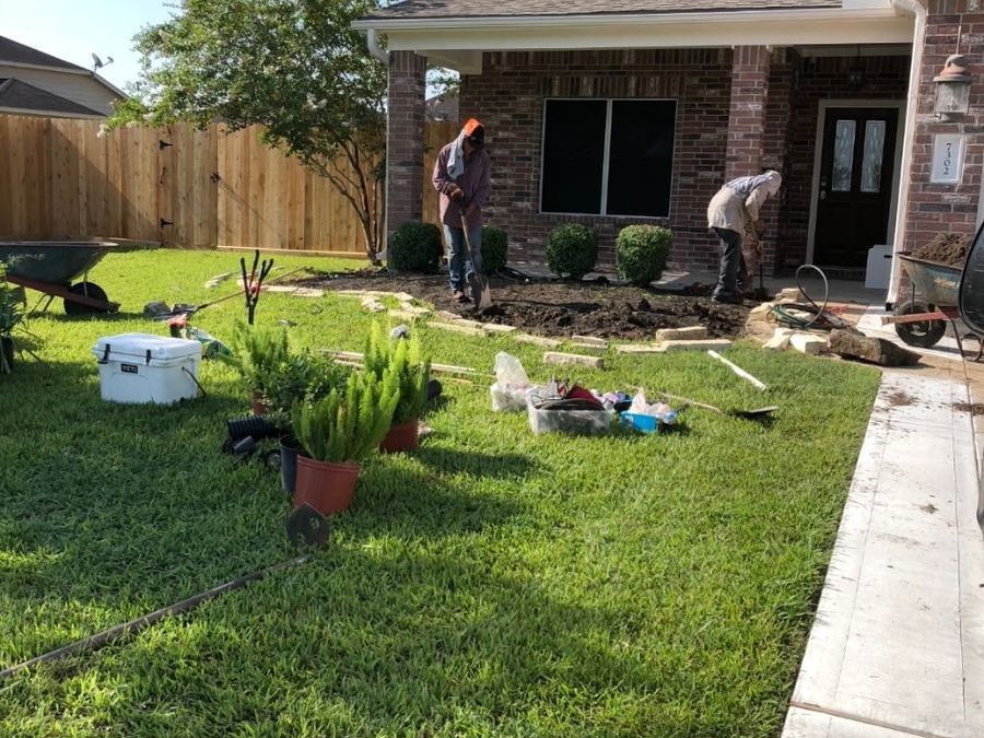 Crew planting shrubs during a bed refresh